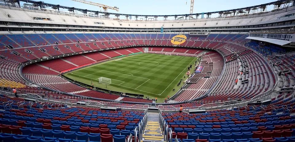 View of empty stadium with green football pitch