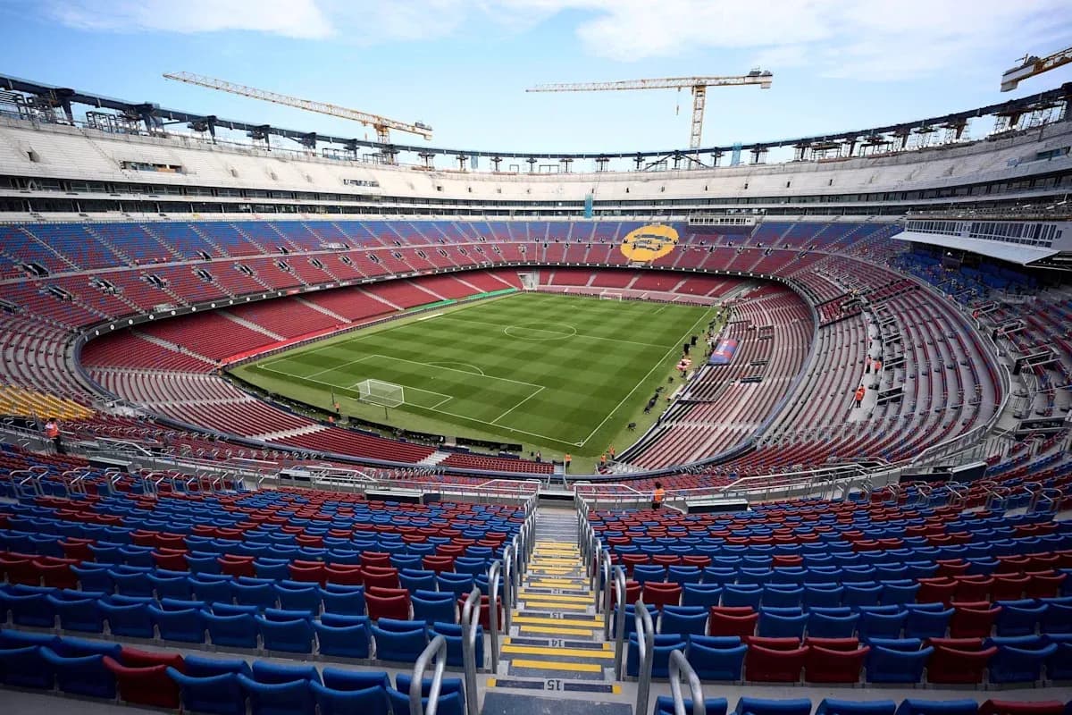 View of empty stadium with green football pitch View of empty stadium with green football pitch