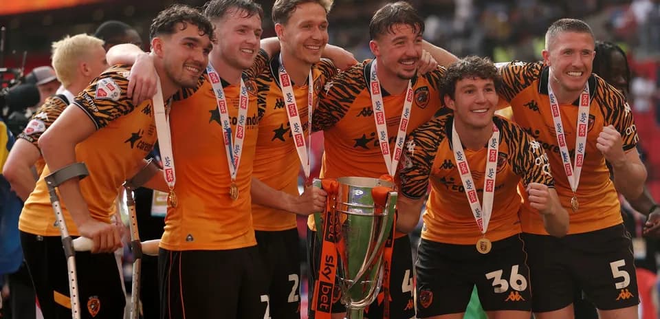 Players celebrating with trophy after winning match