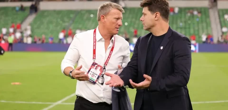Two coaches discussing on the field after match