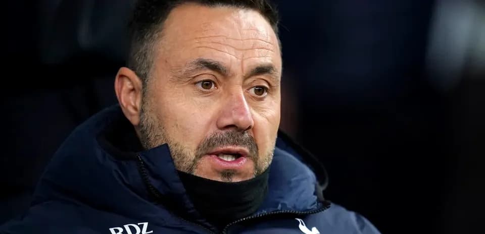 Coach in Tottenham jacket during match