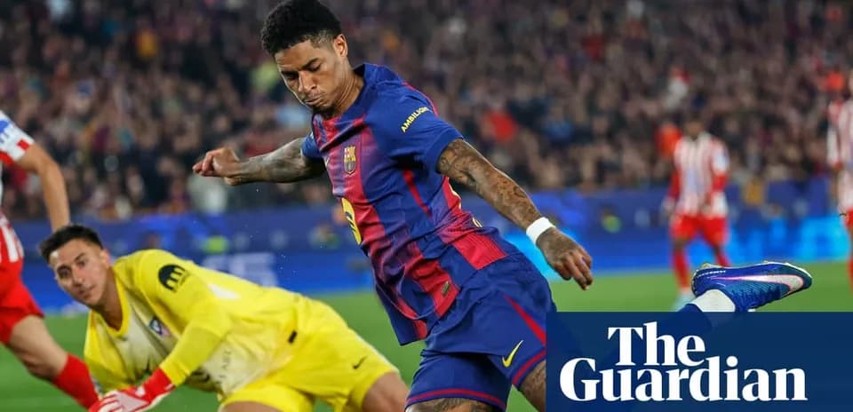 Barcelona player shooting towards goal past goalkeeper