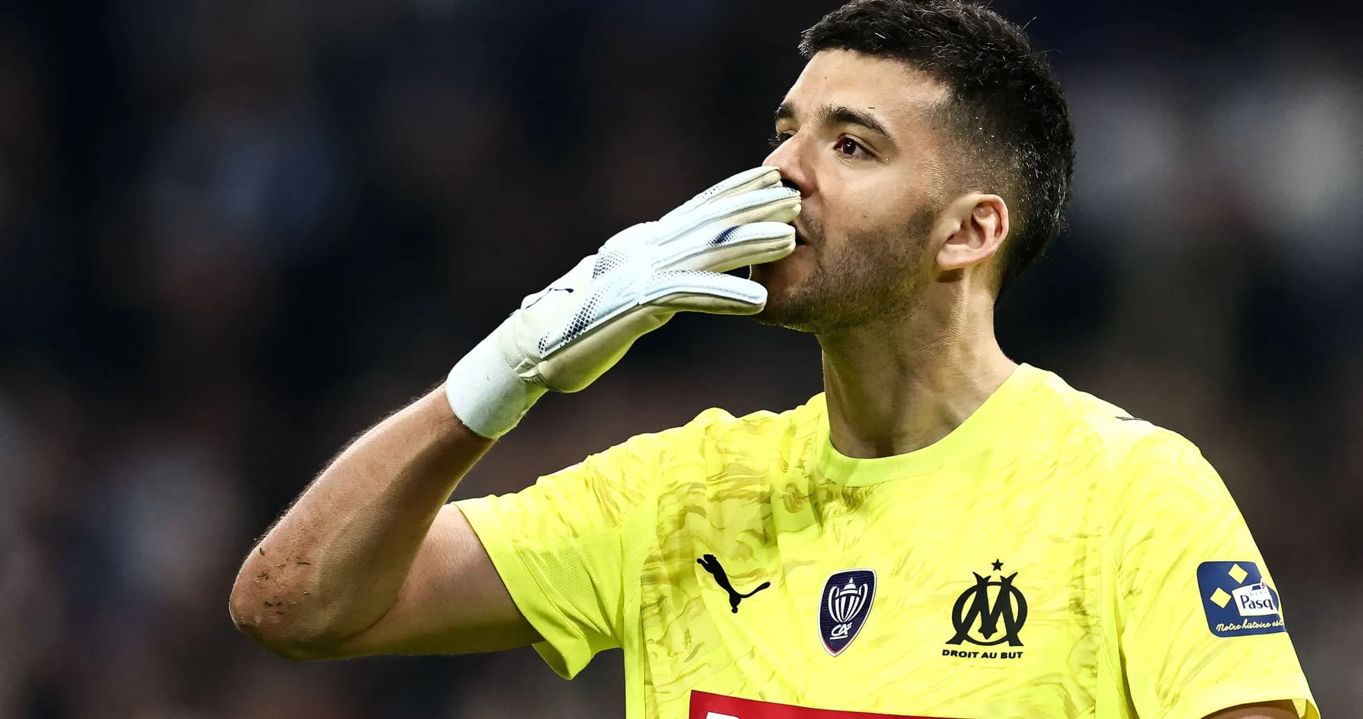 Goalkeeper celebrating with gloves raised during match