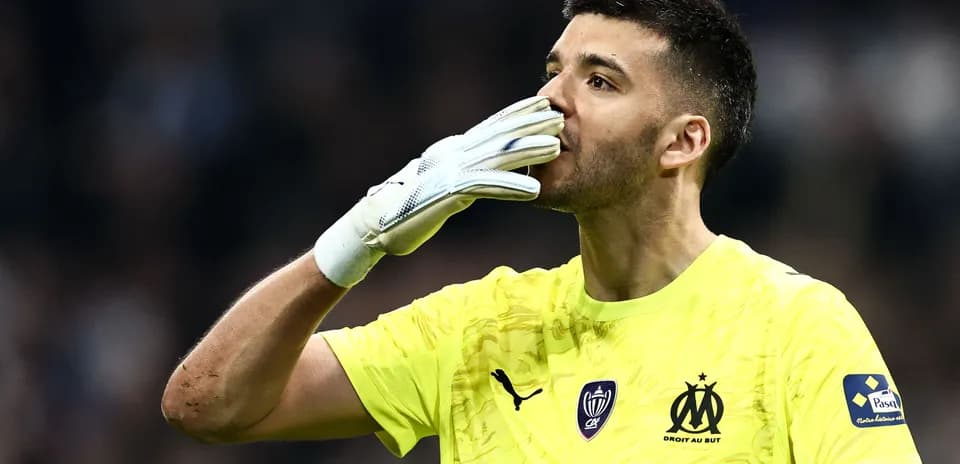Goalkeeper celebrating with gloves raised during match