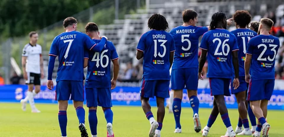 Players celebrating a goal in blue jerseys