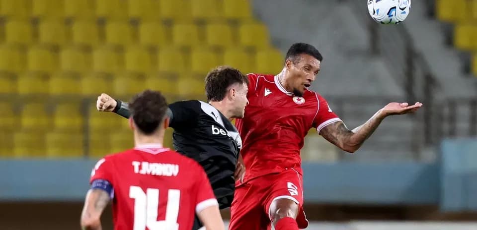 CSKA Sofia player challenging OFI opponent for the ball