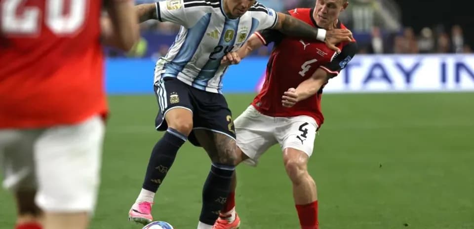 Player dribbling the ball while being challenged