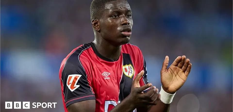 Player in red jersey clapping during match