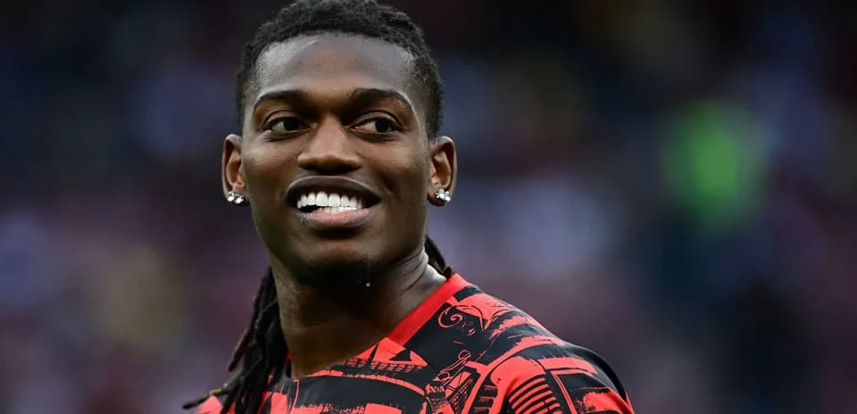 Player smiling in red and black jersey