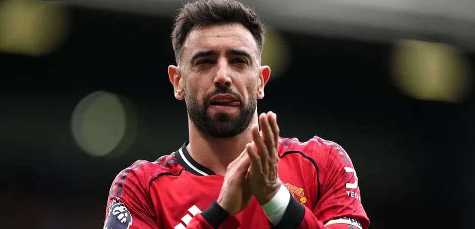 Player applauding fans in Manchester United kit