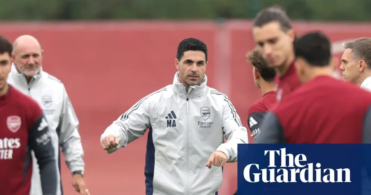 Manager instructing players during Arsenal training session