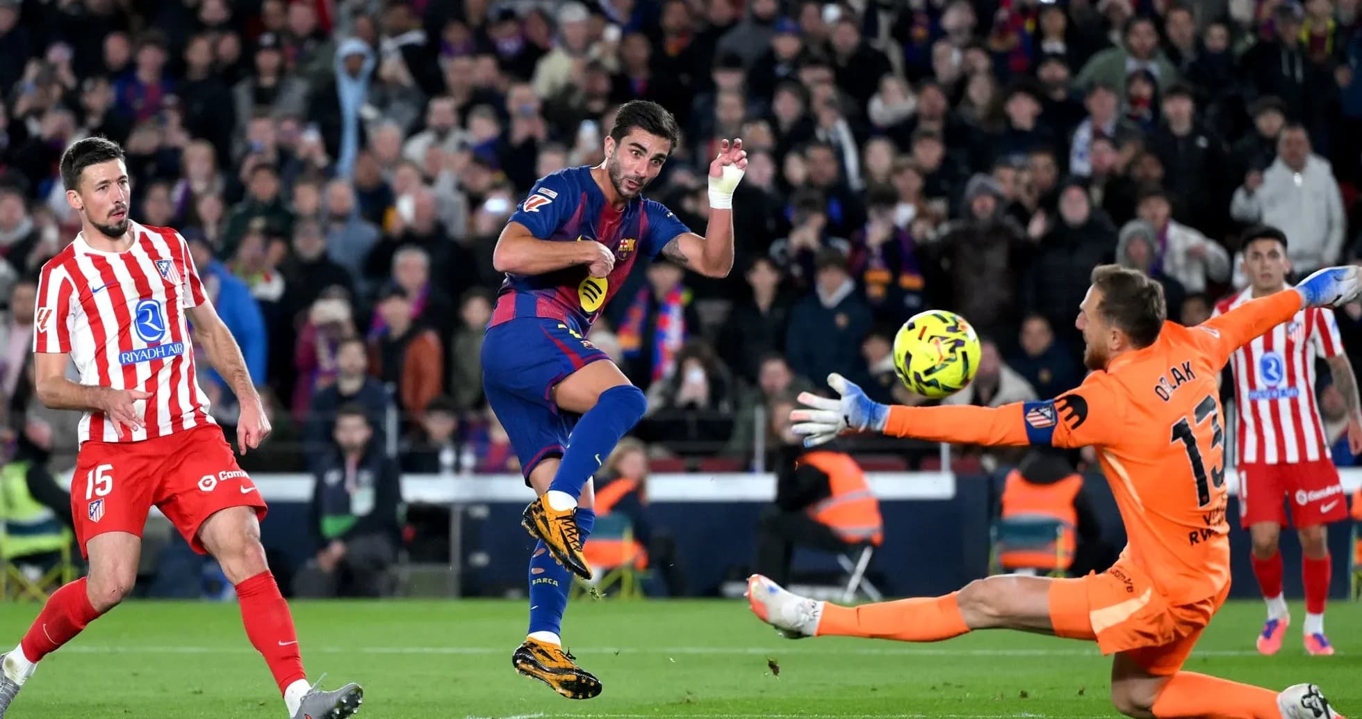 Barcelona player attempting to score against Atletico Madrid