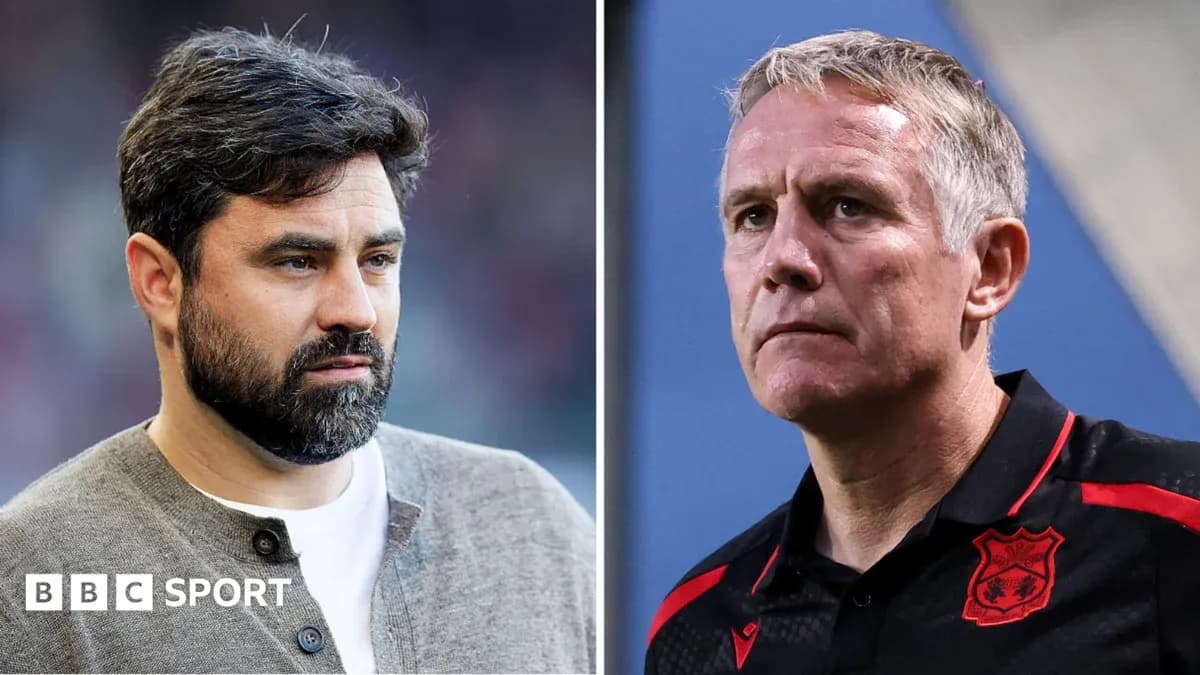 Two football managers on the sidelines during a match