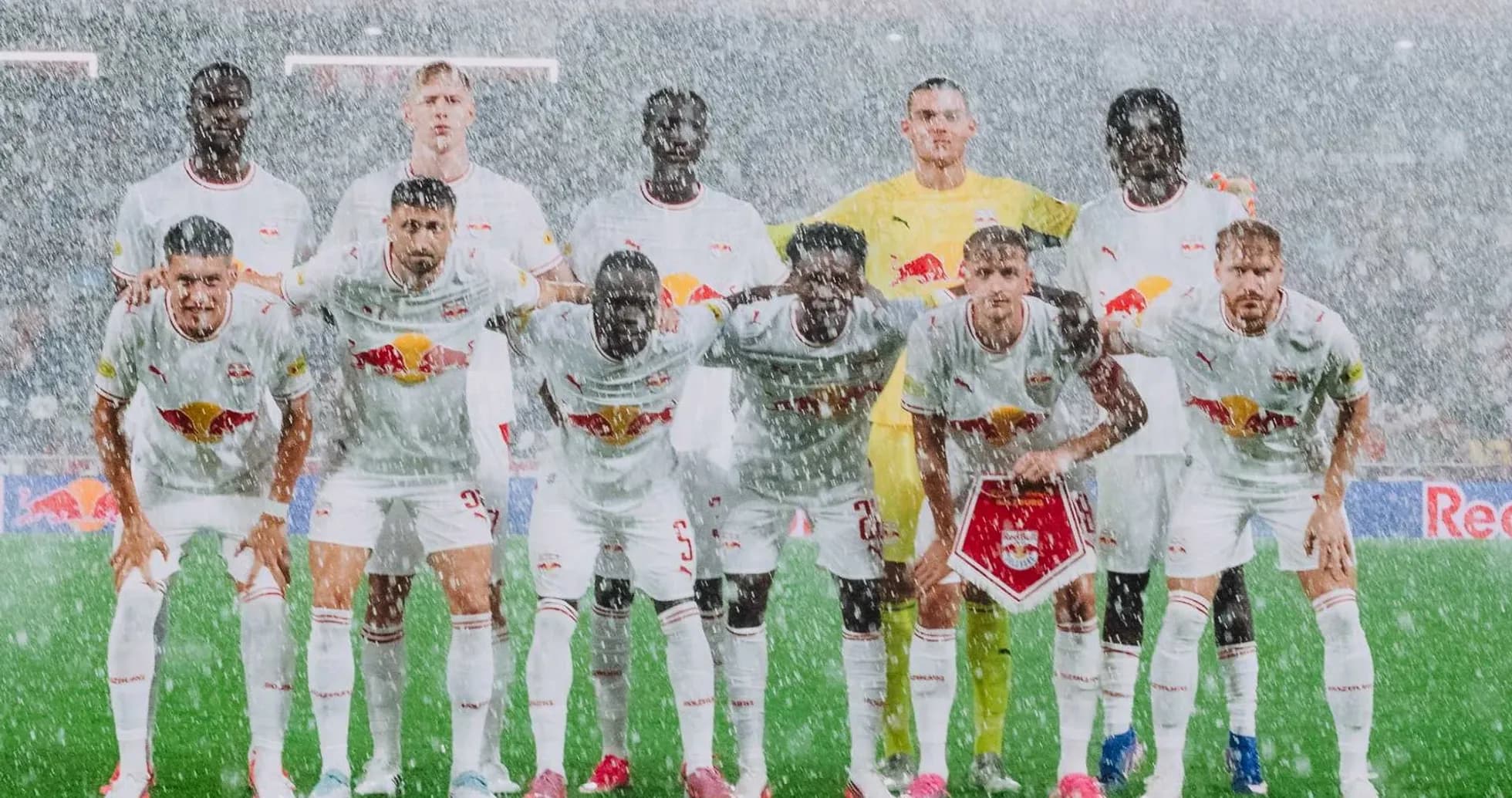 Red Bull Salzburg team posing for photo in rain