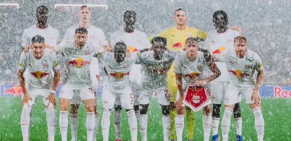 Red Bull Salzburg team posing for photo in rain