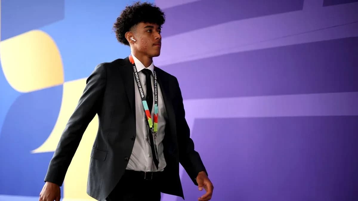 Player walking in suit with FIFA World Cup lanyard