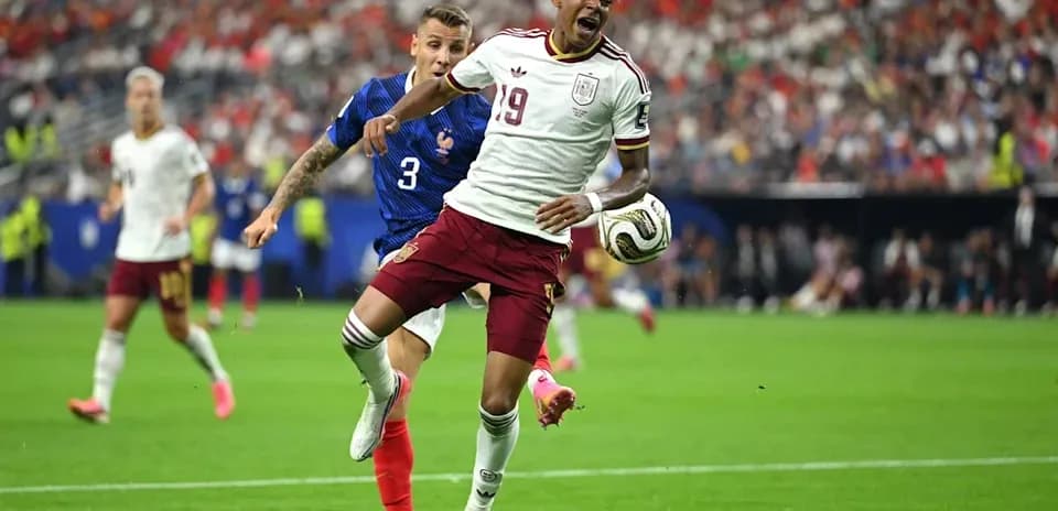 Player in white jersey challenged by opponent in blue