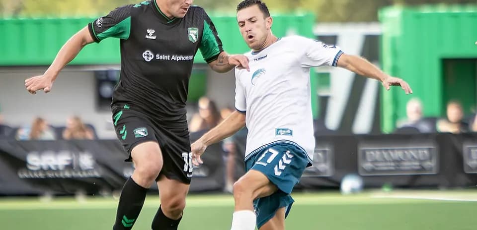 Two players contesting for the ball in match