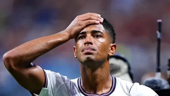 Player holding head in disappointment on the field