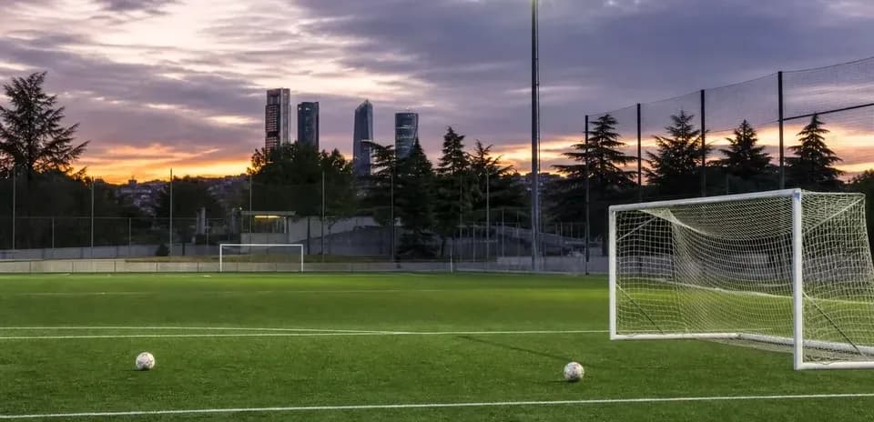 Soccer field with goalposts and sunset skyline