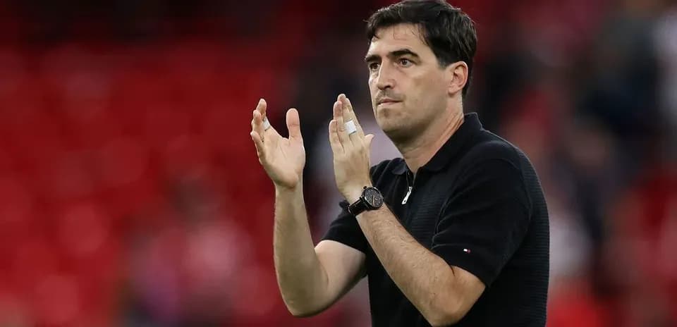 Coach clapping hands during match on field