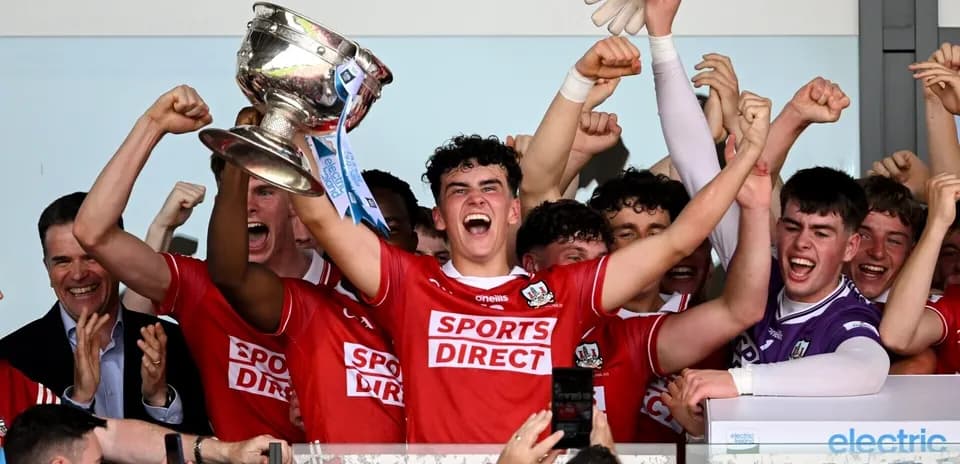 Team celebrating victory with trophy in hands