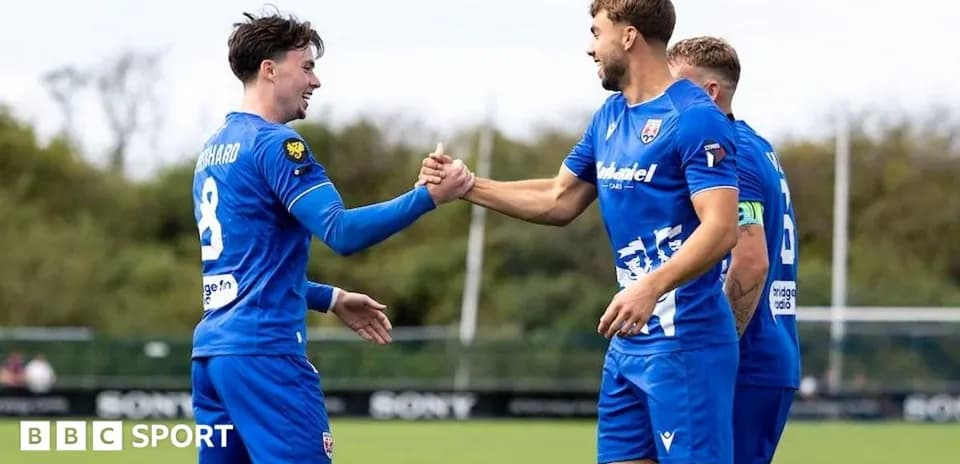 Players celebrating with a handshake during training
