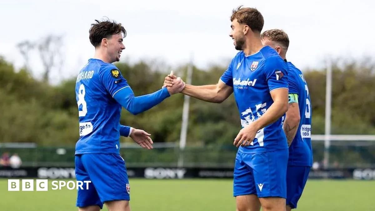 Players celebrating with a handshake during training