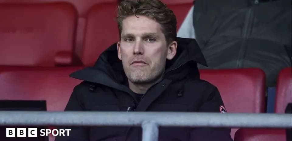 Man sitting in stadium stands during match