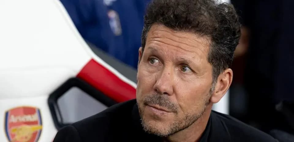 Coach sitting on bench during match preparations