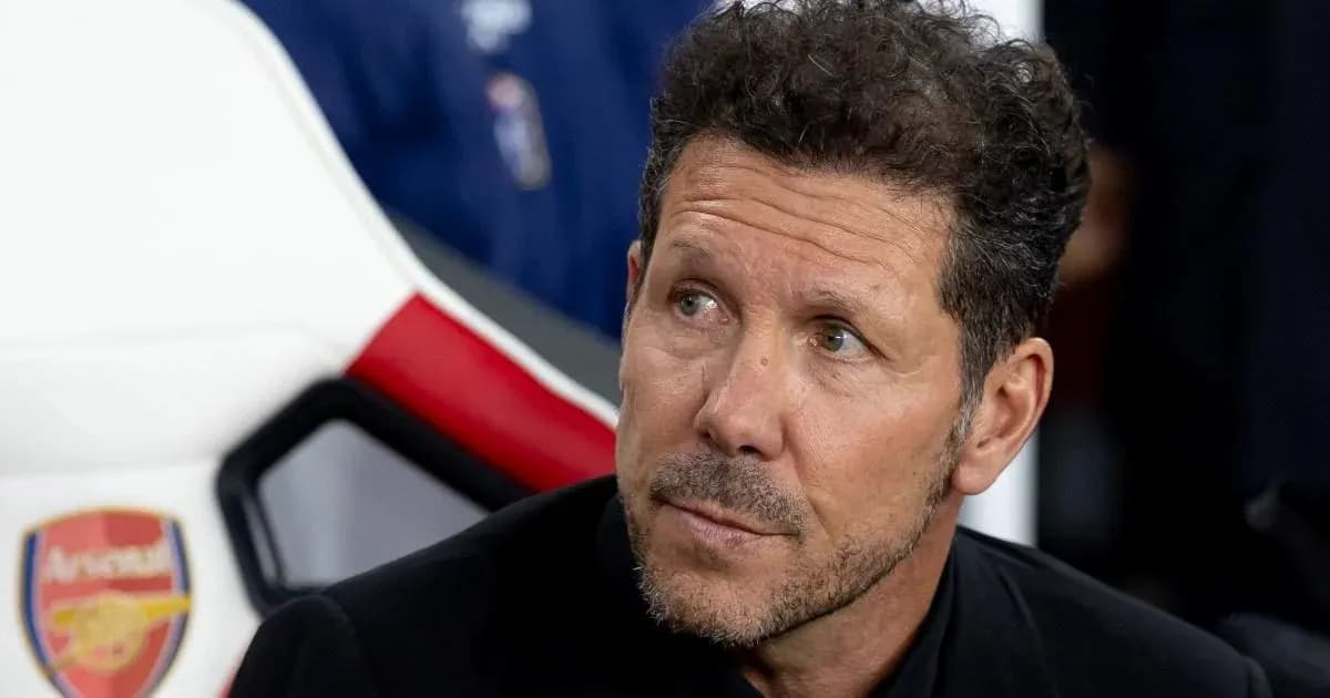 Coach sitting on bench during match preparations
