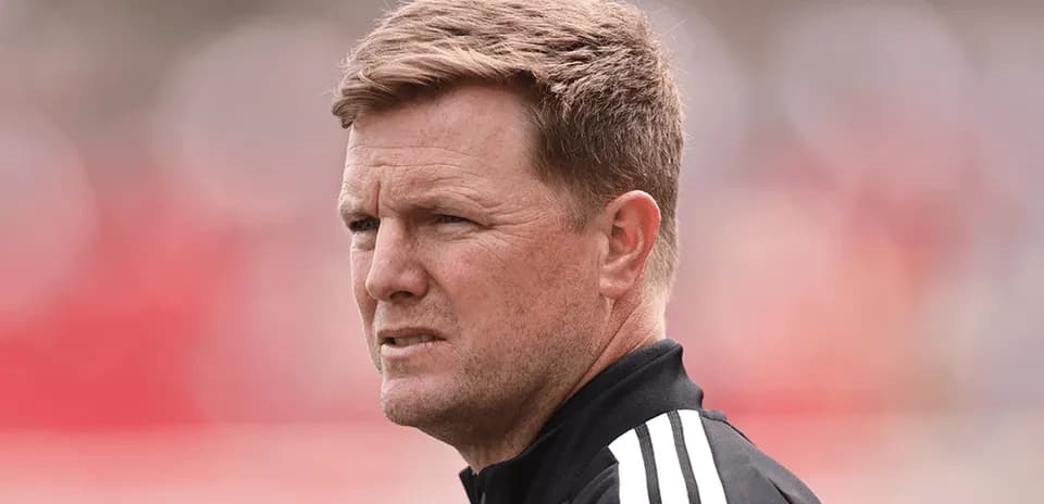 Coach observing match with focused expression
