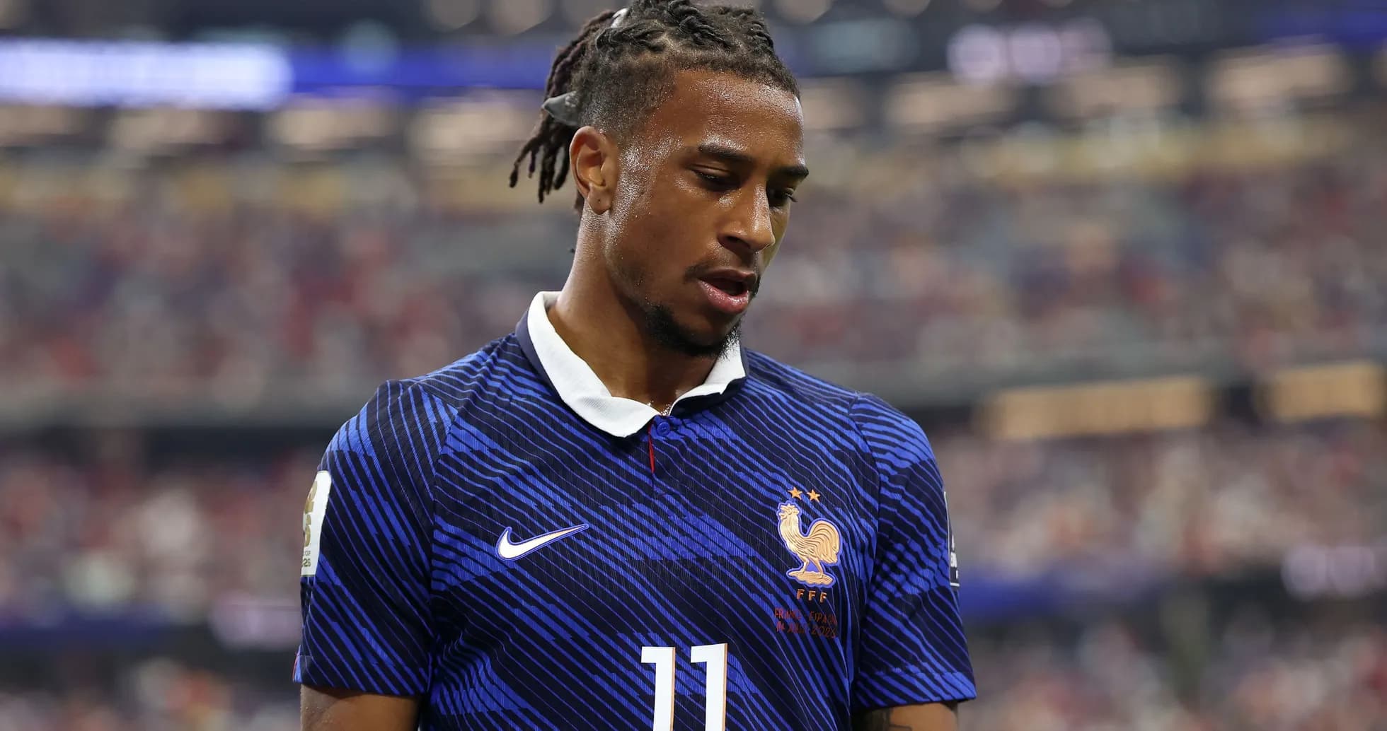 Player in France jersey during match, looking down