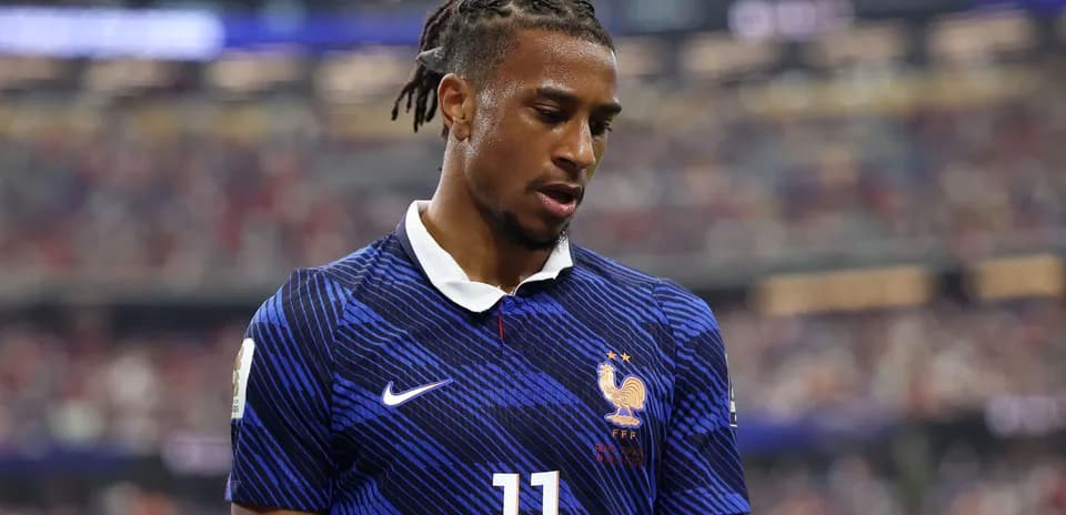 Player in France jersey during match, looking down