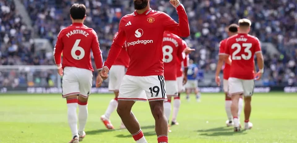 Player celebrating goal with teammates in match