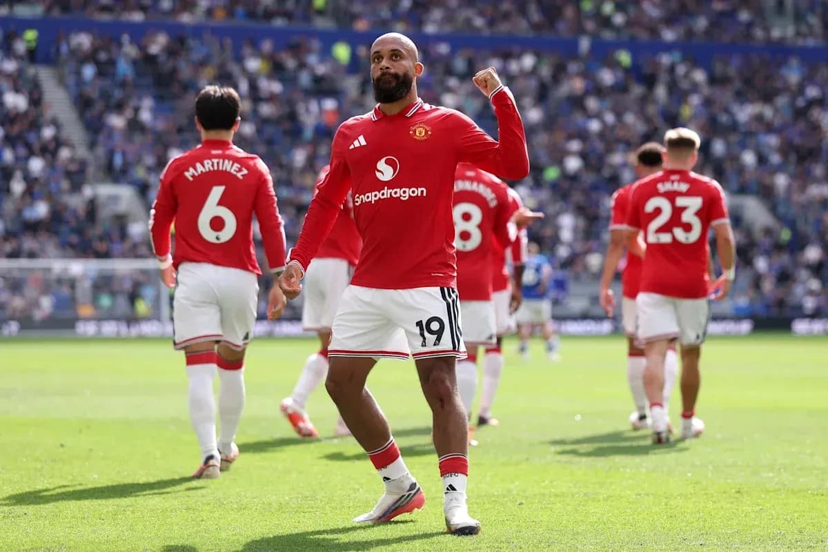 Player celebrating goal with teammates in match