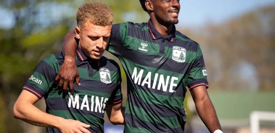 Two players celebrating for Portland Hearts of Pine