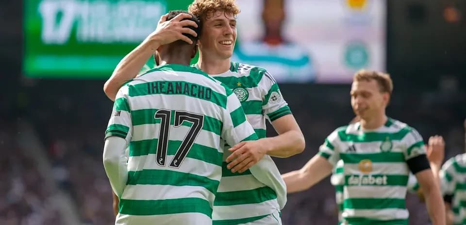 Celtic players celebrating a goal together on pitch