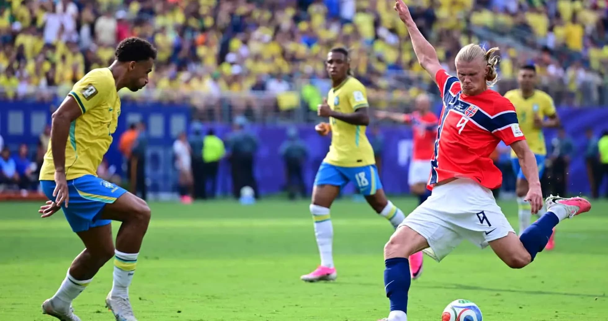 Brazil player defending against Norway forward
