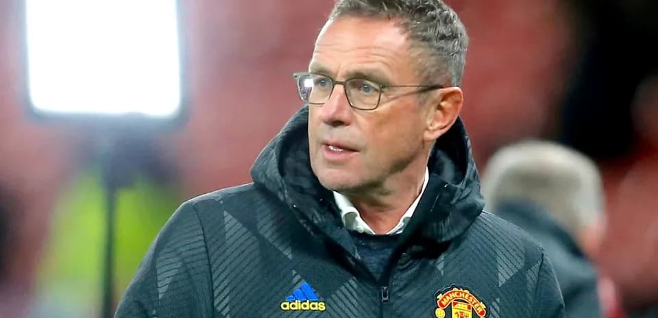Coach in Manchester United jacket during match