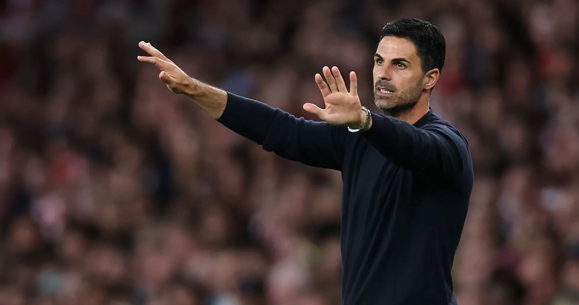 Manager gesturing during a match from the sidelines