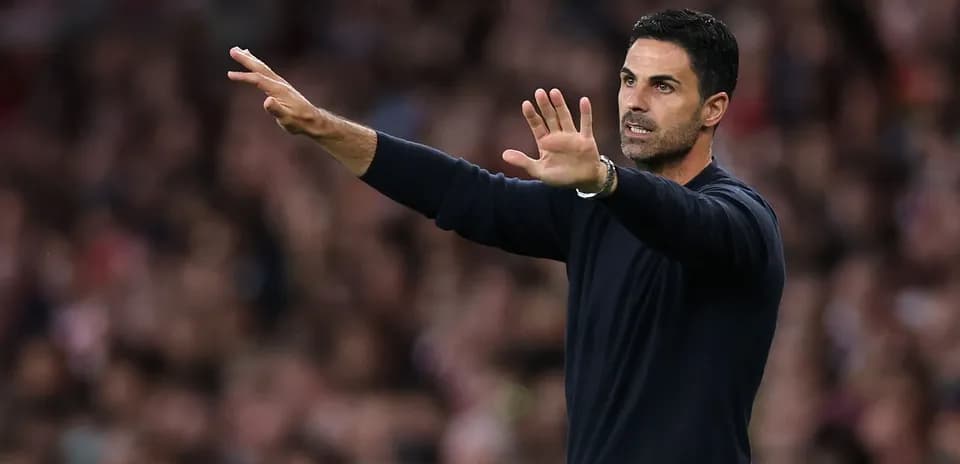 Manager gesturing during a match from the sidelines