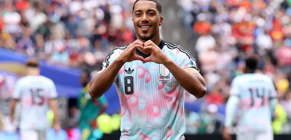 Player celebrating by making heart gesture on field