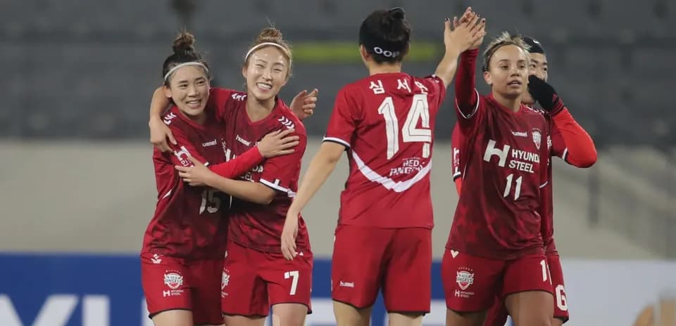 Players celebrating after a goal in WK-League match