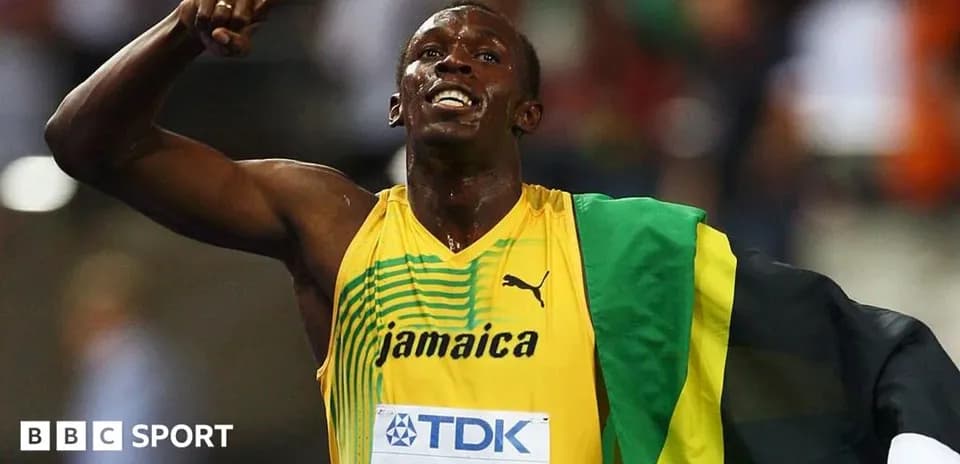 Athlete celebrating victory with Jamaican flag