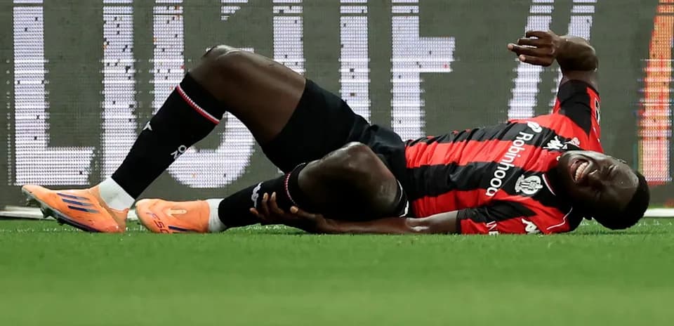 Player on the ground holding injured leg during match