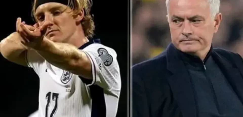Player celebrating goal alongside manager during match