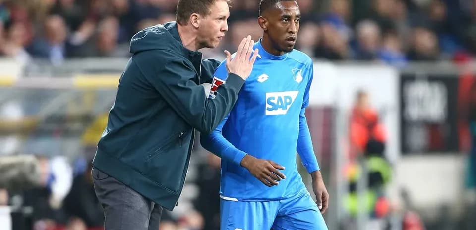 Coach giving instructions to player on the field