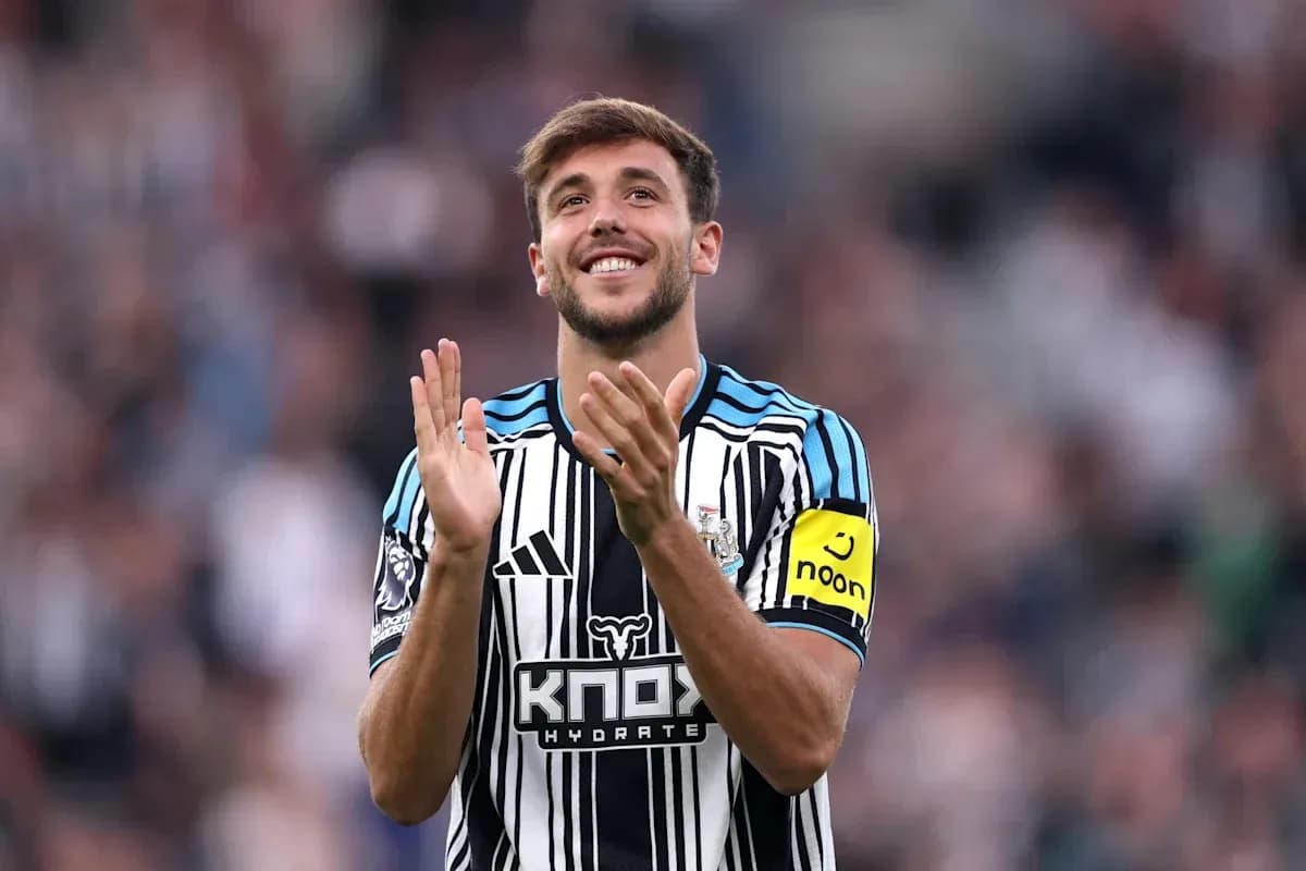 Player clapping and smiling in Newcastle kit