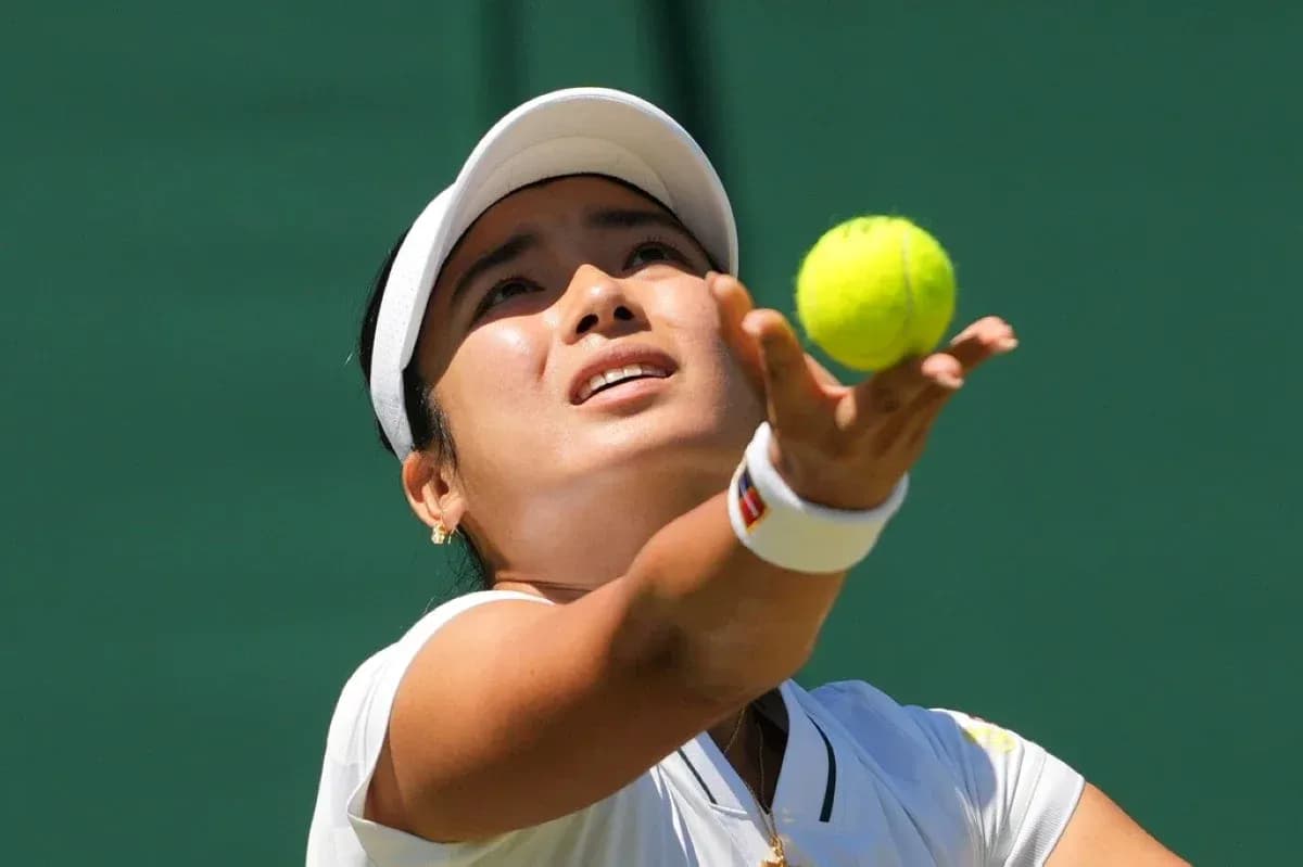 Tennis player serving a ball during match